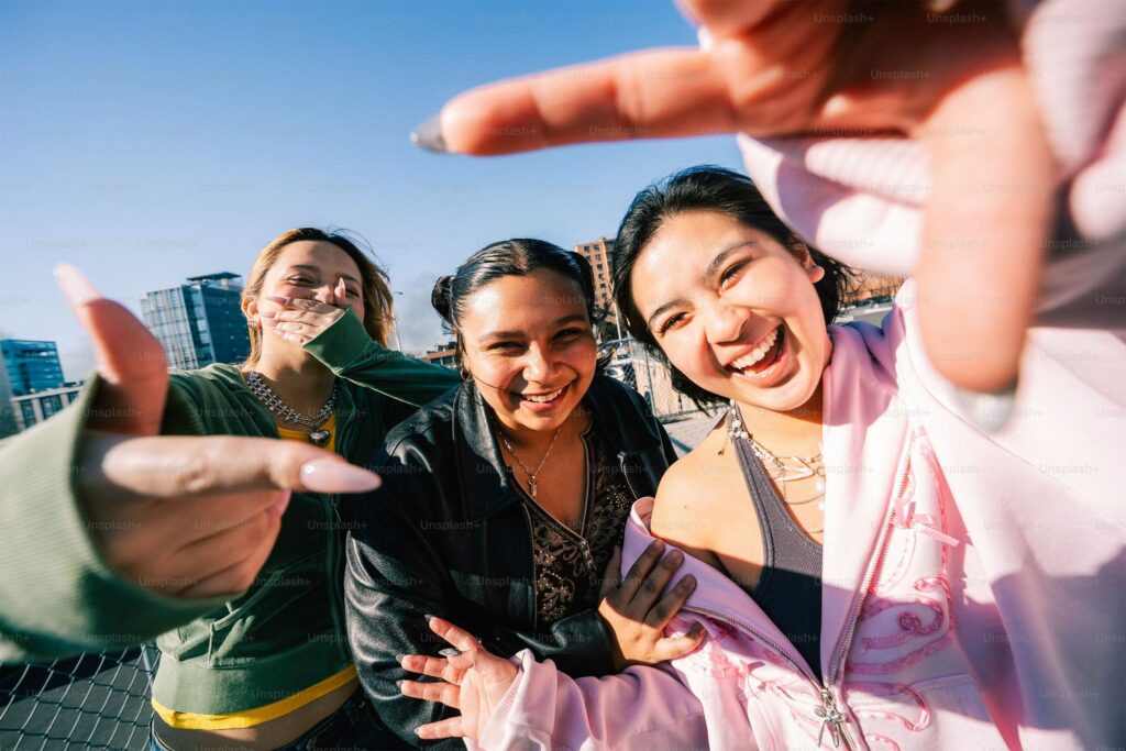 Group of young people pointing at the camera