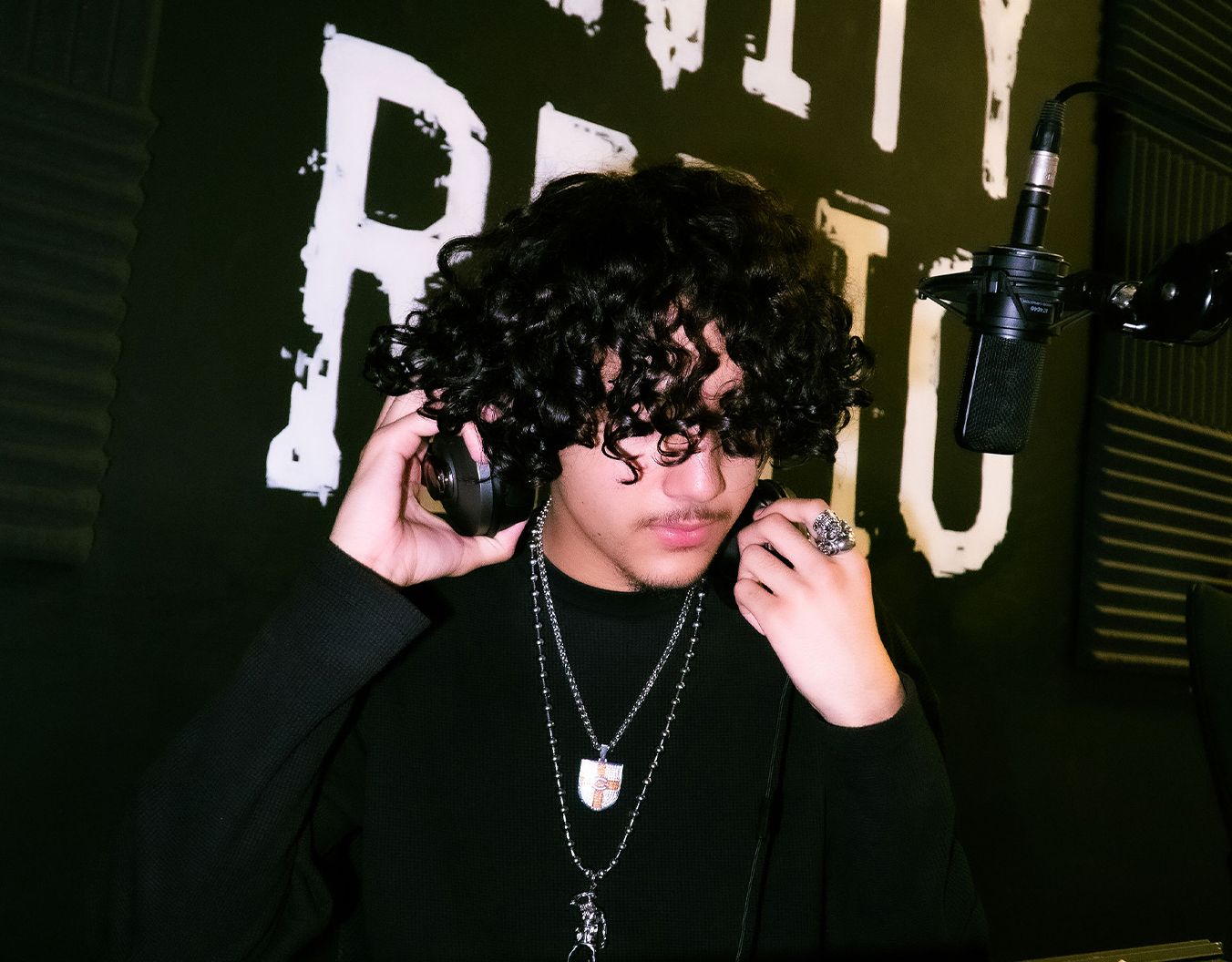 a young man putting headphones on
