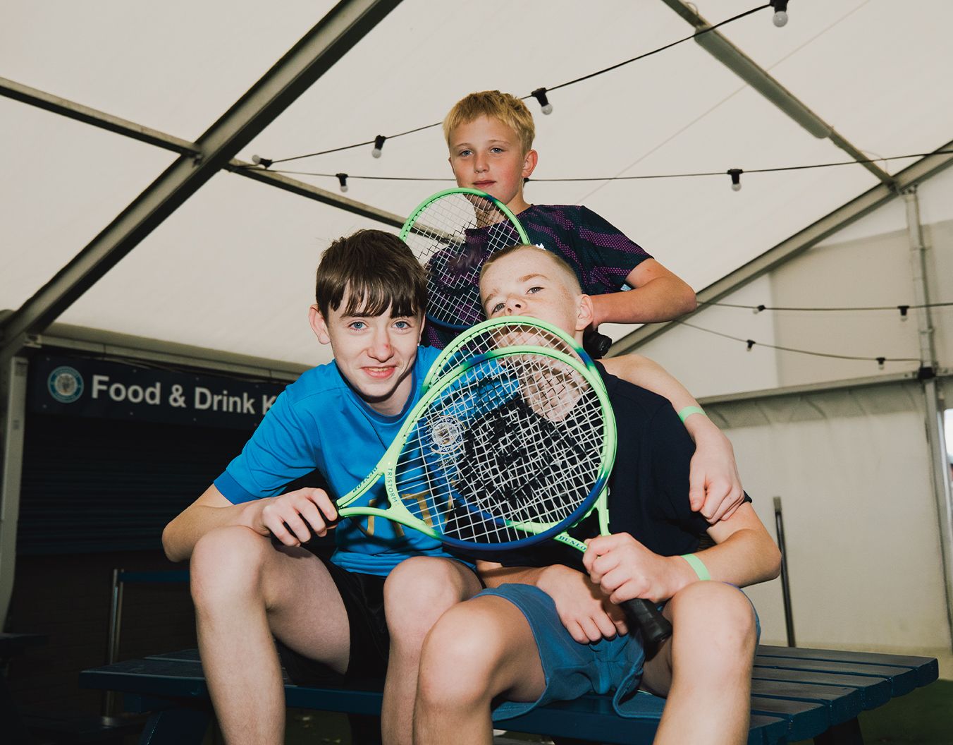 3 children posing with tennis rackets